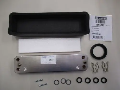 Remeha Plattenwärmetauscher mit Anschlussmöglichkeiten, Dichtungen, Schrauben und Verpackung auf neutralem Hintergrund.